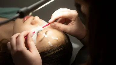 woman in lash salon getting lashes done