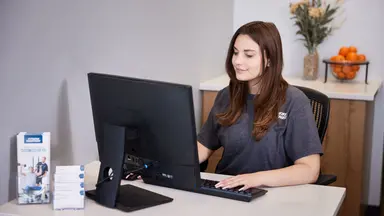 woman at desk working on computer
