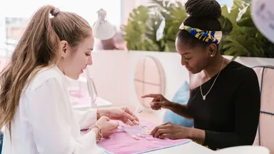 A woman getting her nails done at the nail salon