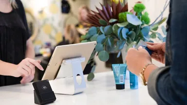 A customer making a payment at the salon