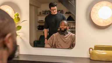 A man getting a haircut at the barbershop
