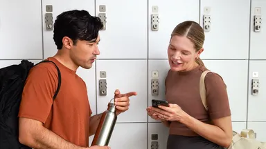 Two people talking outside a Pilates Class