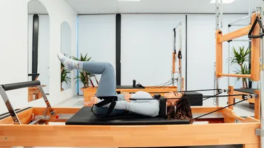 A woman doing Pilates on the reformer