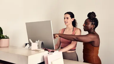 Two employees at the front desk
