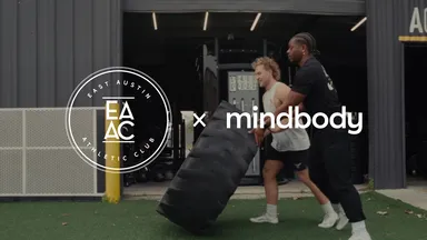 2 people working out with a tire