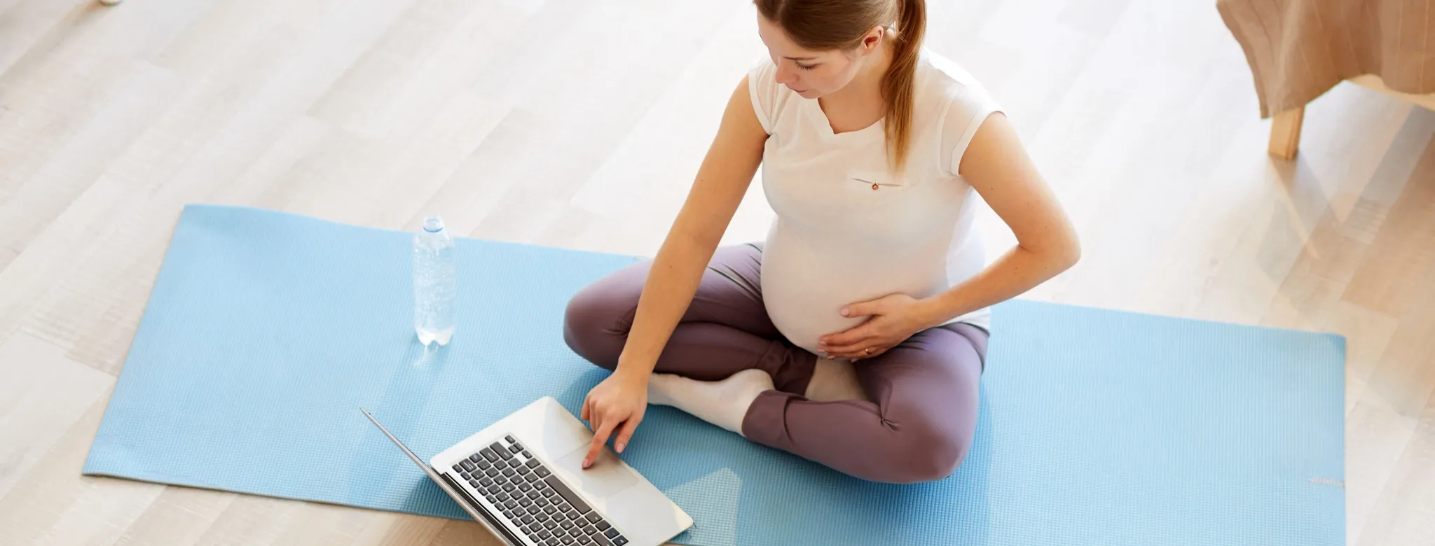 Pregnant woman working out from home virtually