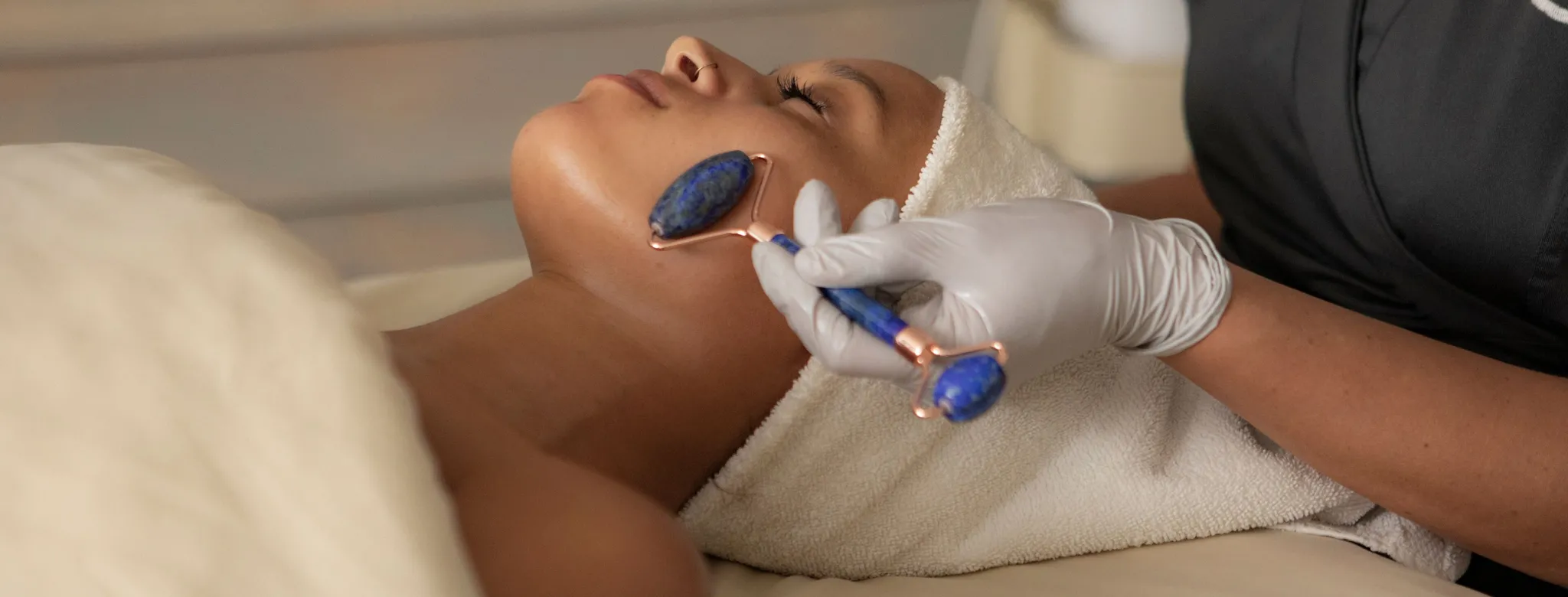 woman at spa on table with jade roller