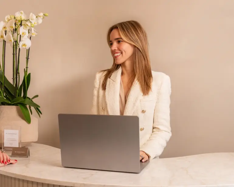 A salon owner working at her front desk